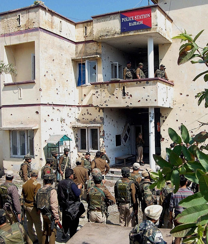 Jammu: Police personnel during an encounter with the militants at Raj Bagh Police station, Jammu on Friday. PTI Photo (PTI3_20_2015_000063B)